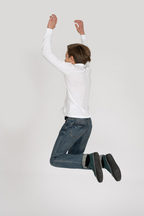 Young man in casual clothes jumping