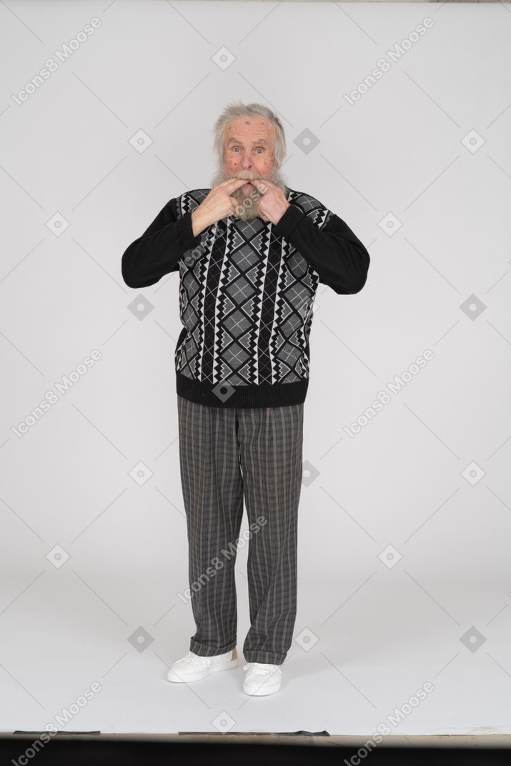 Old man with fingers in mouth whistling