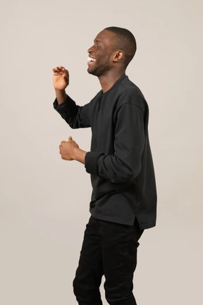 Side view of young happy man with eyes closed