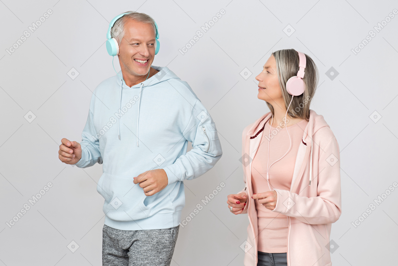 Middle aged couple jogging while listening music