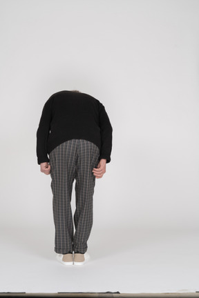 Back view of an elderly man bending over