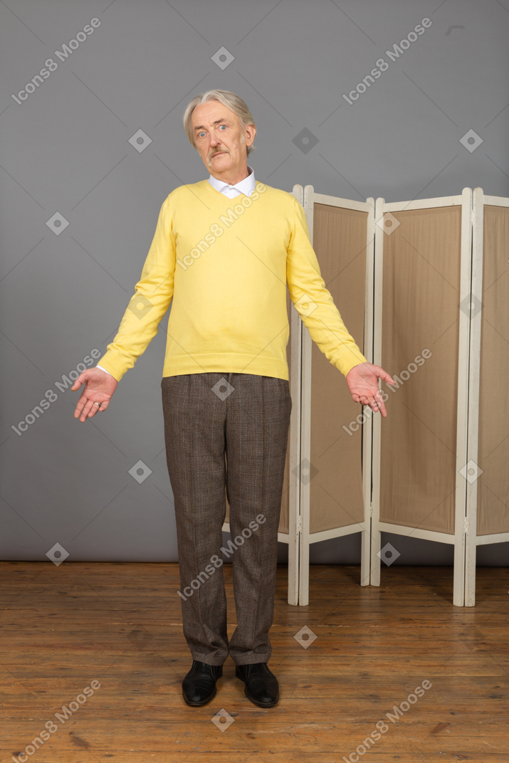 Front view of a questioning old man looking at camera