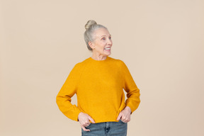 Elegant older woman in a mustard sweater