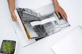 Female hands holding an open black and white photo album