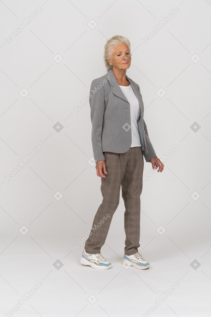 Front view of a thoughtful old lady in suit
