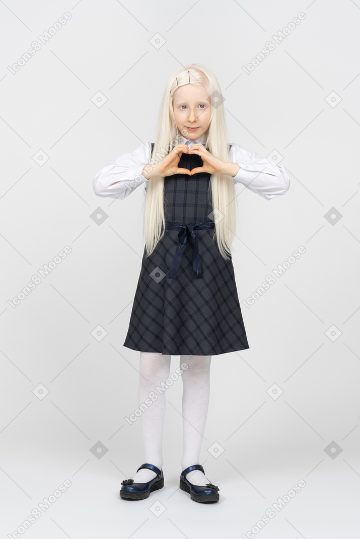 Schoolgirl making a heart with her hands