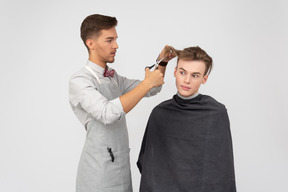 A young barber and his client