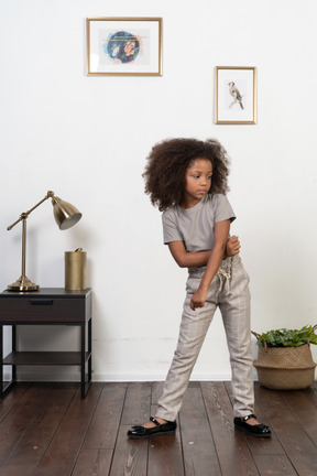 Good looking girl kid posing on the apartment background