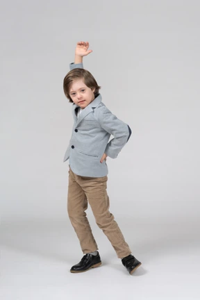 A young boy is posing for a picture