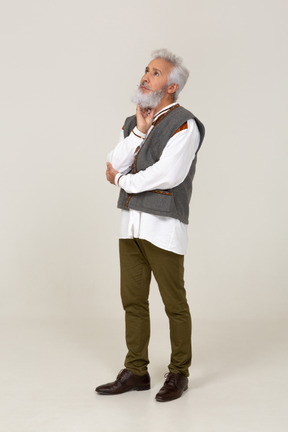 Man in gray vest thinking with head propped