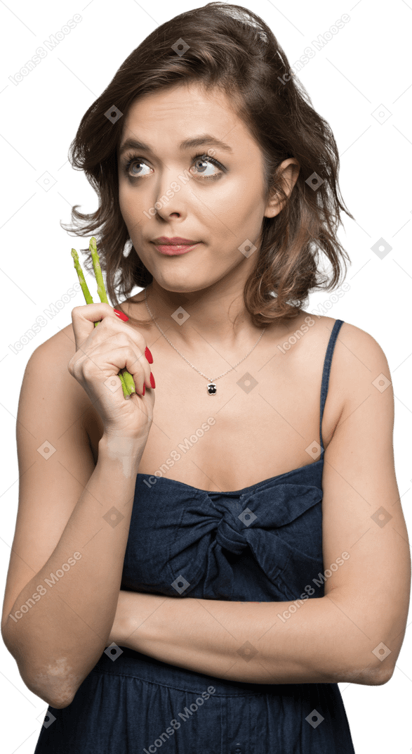 Thoughtful young woman with asparagus