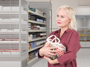 A woman in a pharmacy holding a bag
