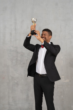 Man holding up award in celebration of his win