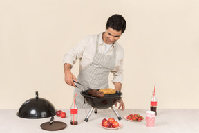 Young caucasian man preparing bbq