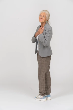 Side view of an old lady in suit looking at camera