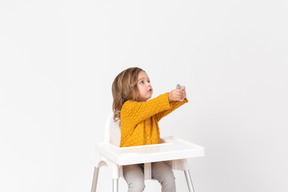 Cute baby girl siting on a highchair
