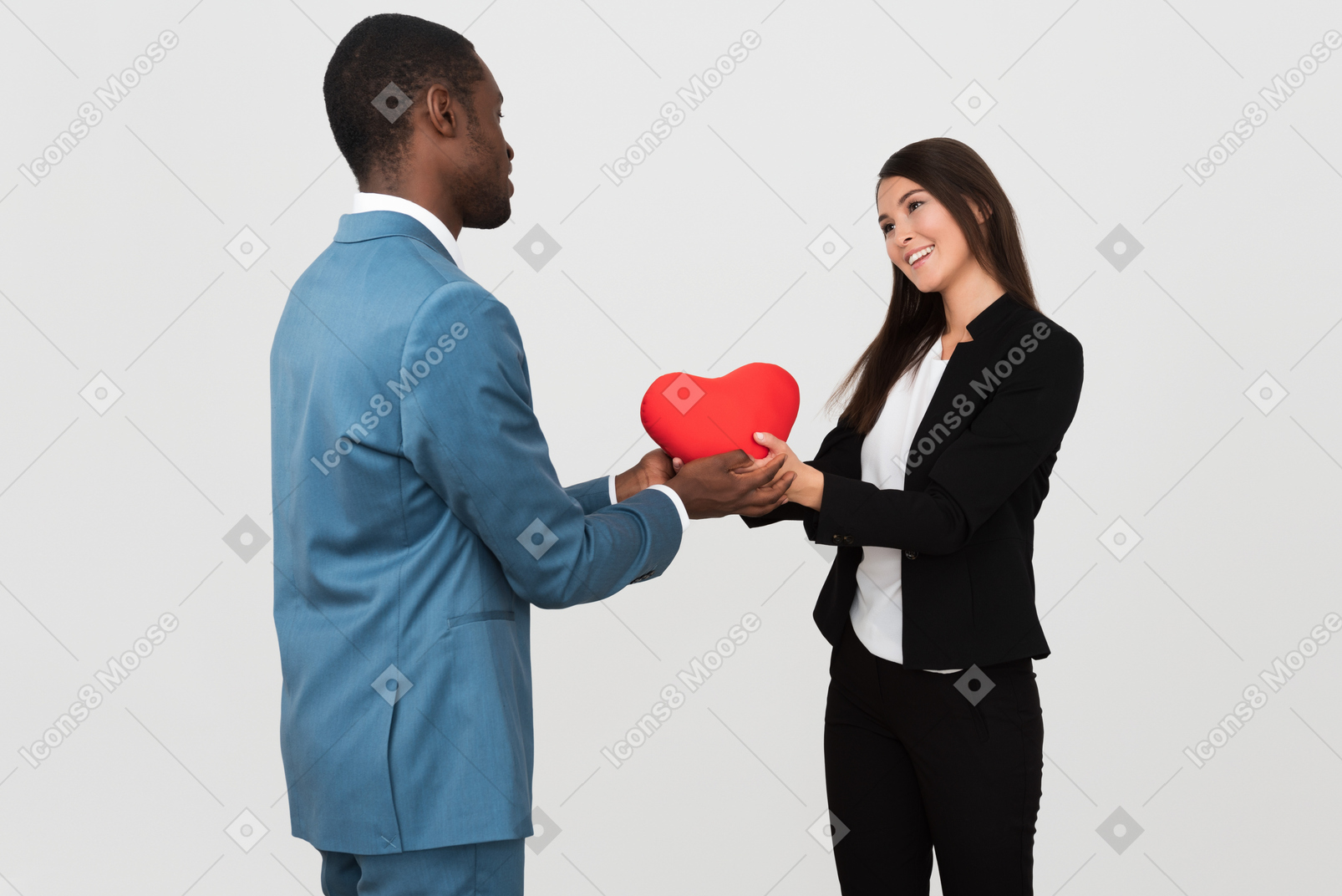 Beautiful interracial couple holding a toy heart together