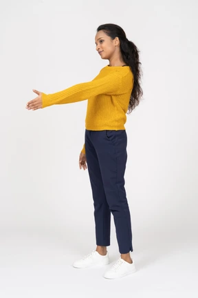 Side view of a girl in casual clothes giving a hand for shake