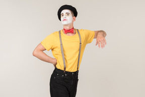 Male mime leaning on invisible object