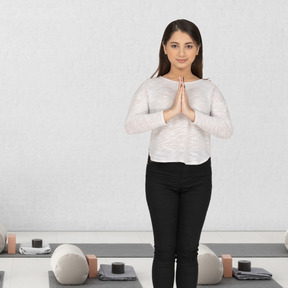 A woman in yoga position standing in the yoga studio