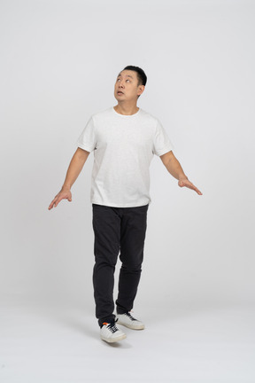 Front view of a man in casual clothes looking up