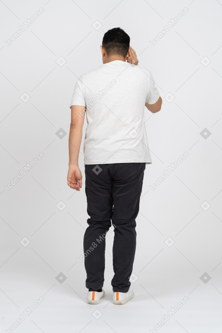 Rear view of a man in casual clothes eavsdropping