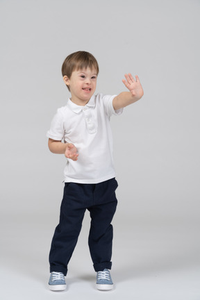 Front view of little boy showing a stop gesture