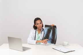 Beautiful female doctor with an x-ray photograph