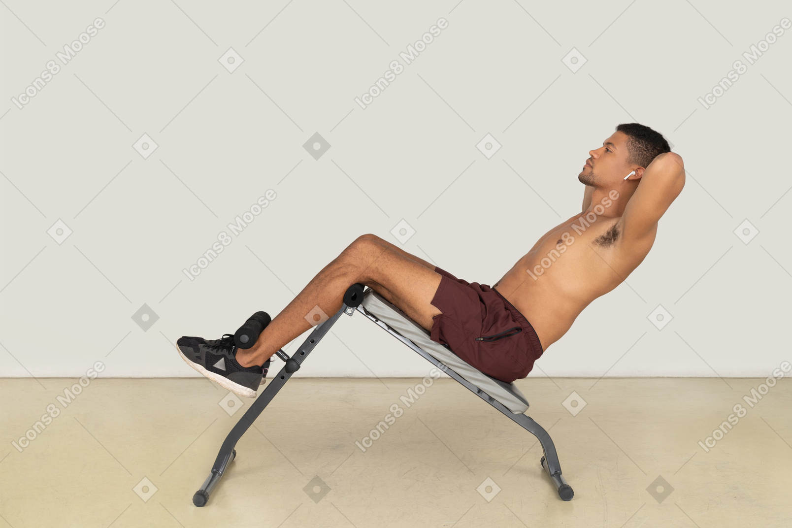 Vista lateral do homem fazendo exercícios abdominais no banco