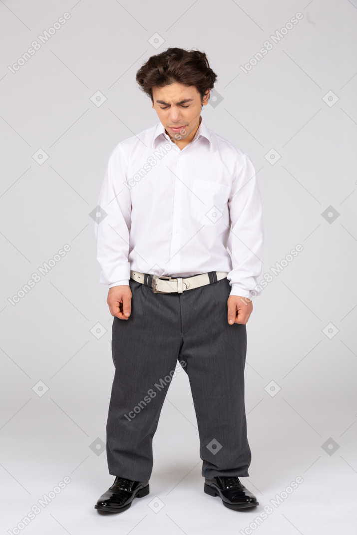 Man in casual business clothes squeezing his eyes