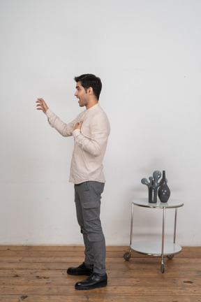 Side view of a man in casual clothes gesturing