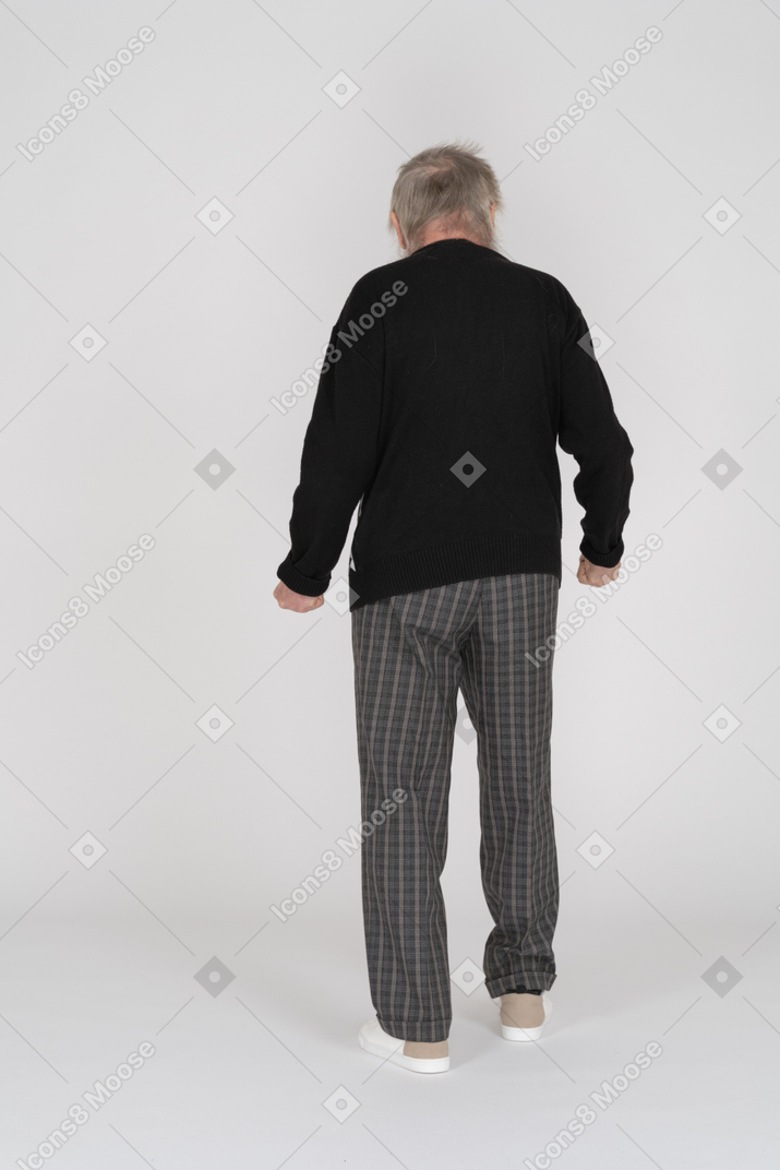 Back view of a senior man with clenched fists
