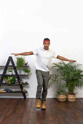 Good looking young man posing on the background of the apartment