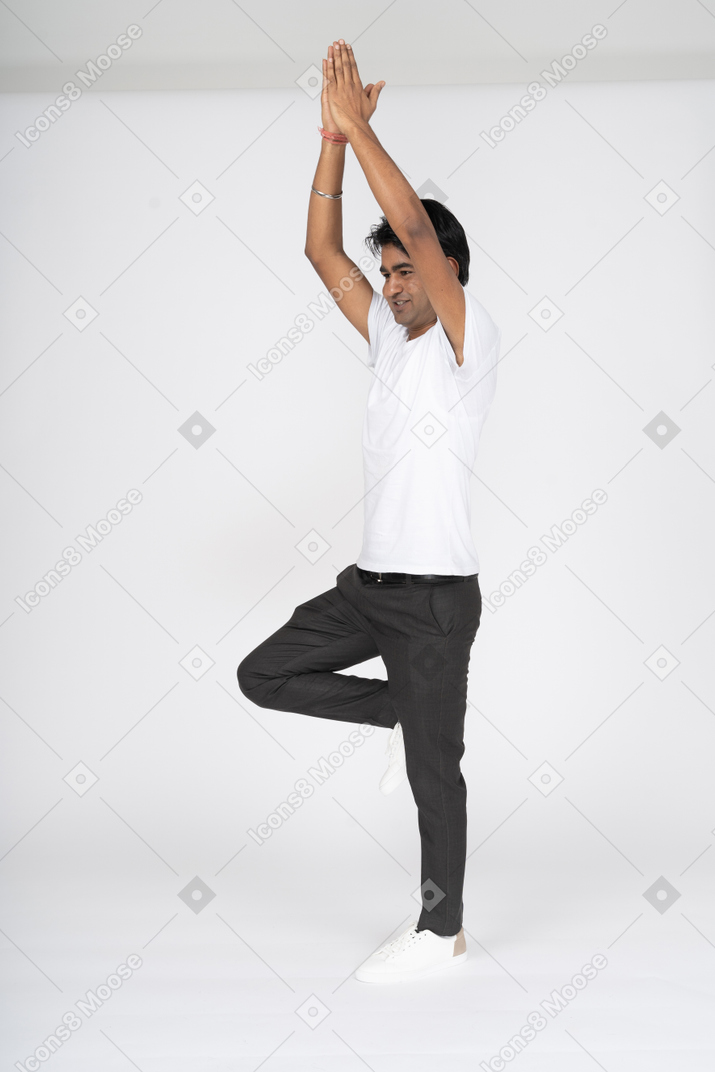 Man in white t-shirt doing yoga