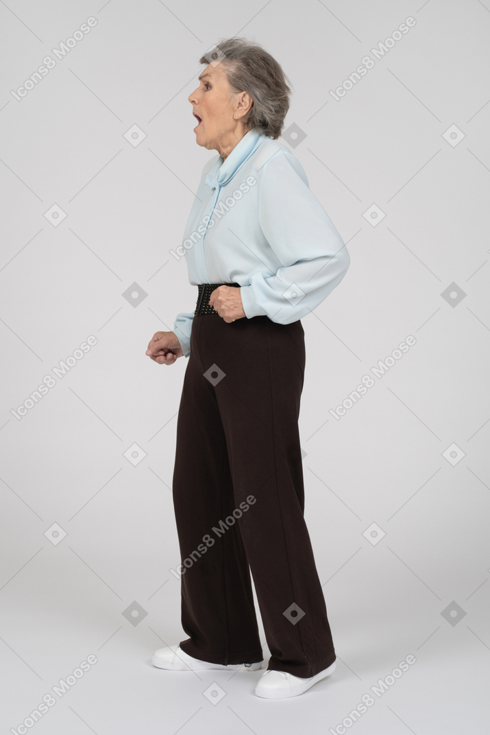 Side view of an old woman gaping in shock