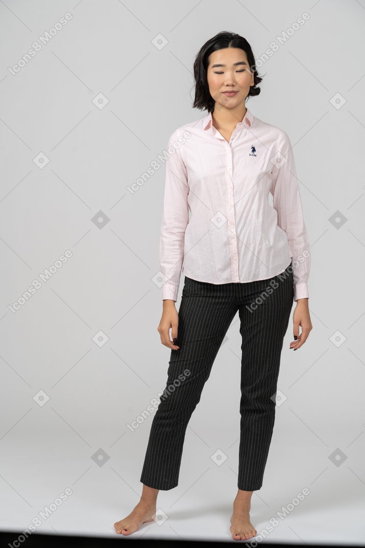 Smiling woman in office clothing with her eyes closed