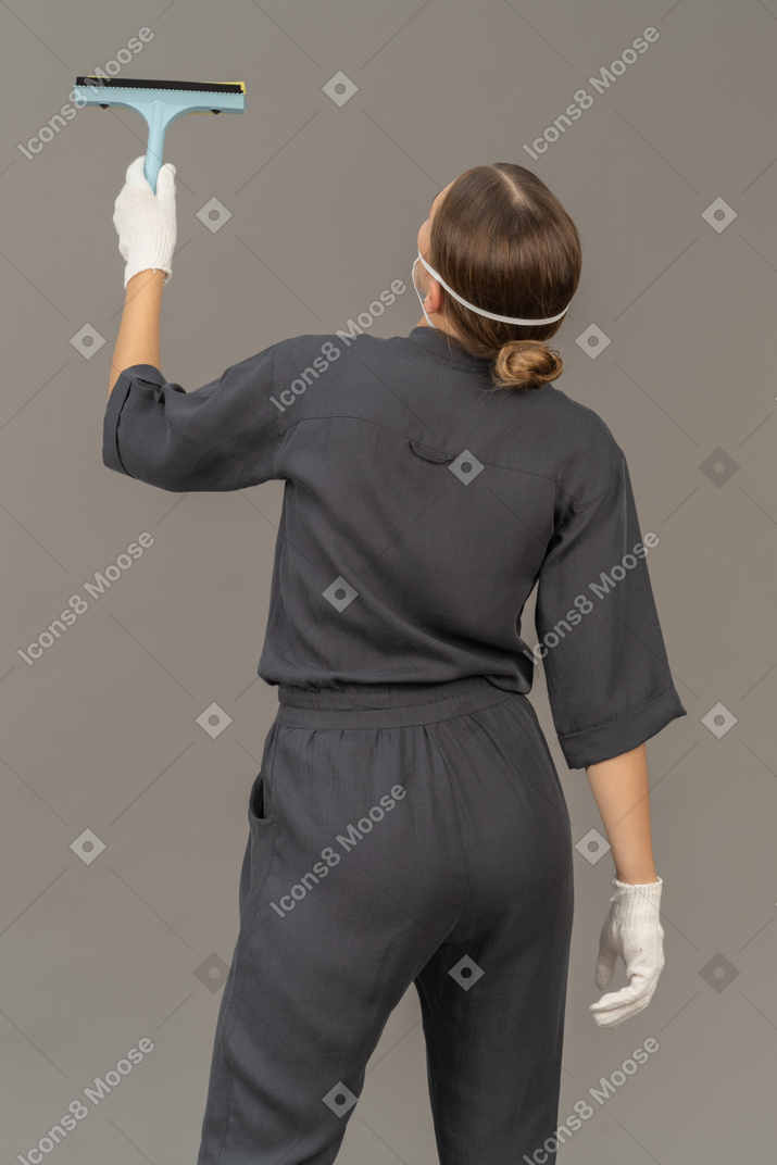 Back view of a woman with a window-cleaning tool