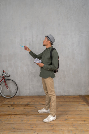 Man looking at something and taking notes