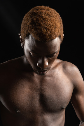 Contrast shot of an african young male looking down