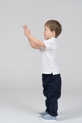 Side view of little boy gesturing