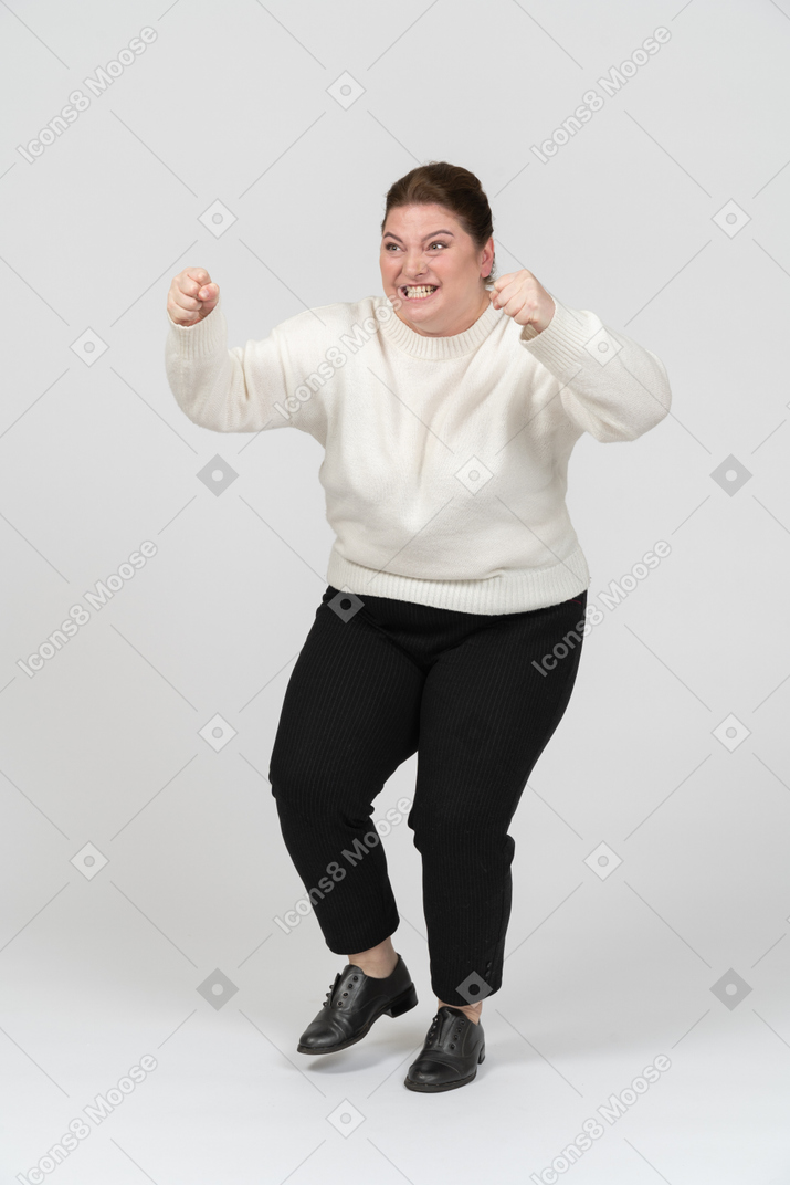 Angry plump woman in casual clothes fighting