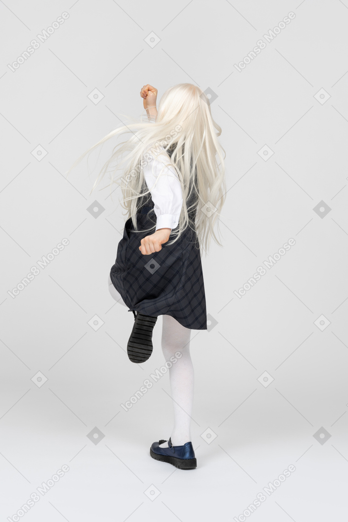 Back view of a schoolgirl skipping