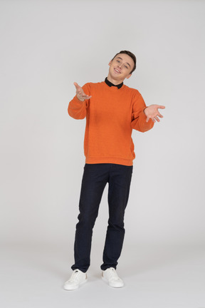 Young man in orange sweatshirt standing