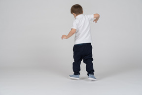 Rear view of little boy dancing