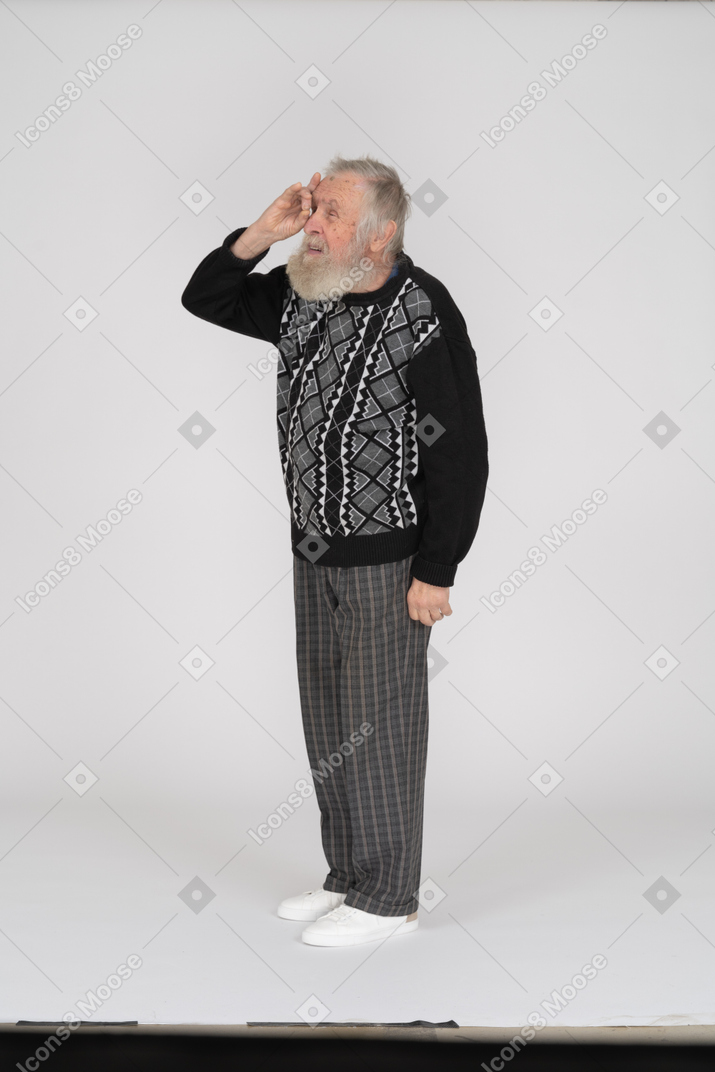 Old man looking into hand monocular