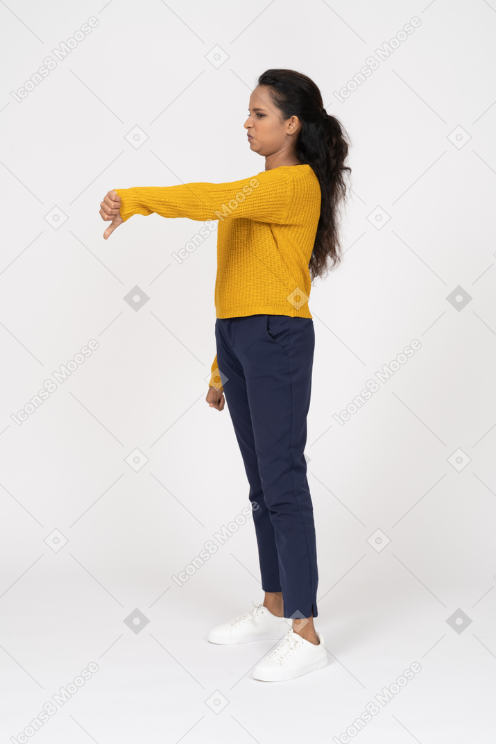 Side view of a girl in casual clothes showing thumb down