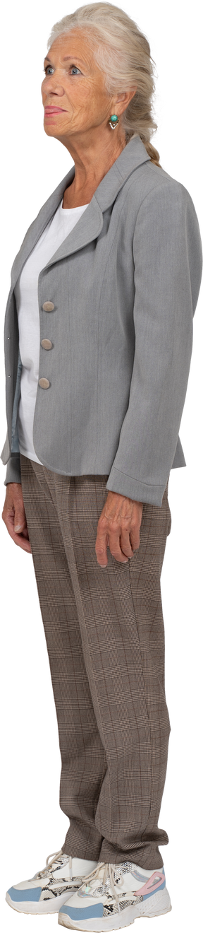 Side view of an old lady in suit showing tongue