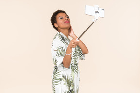 Seductive looking adult afro woman taking a selfie