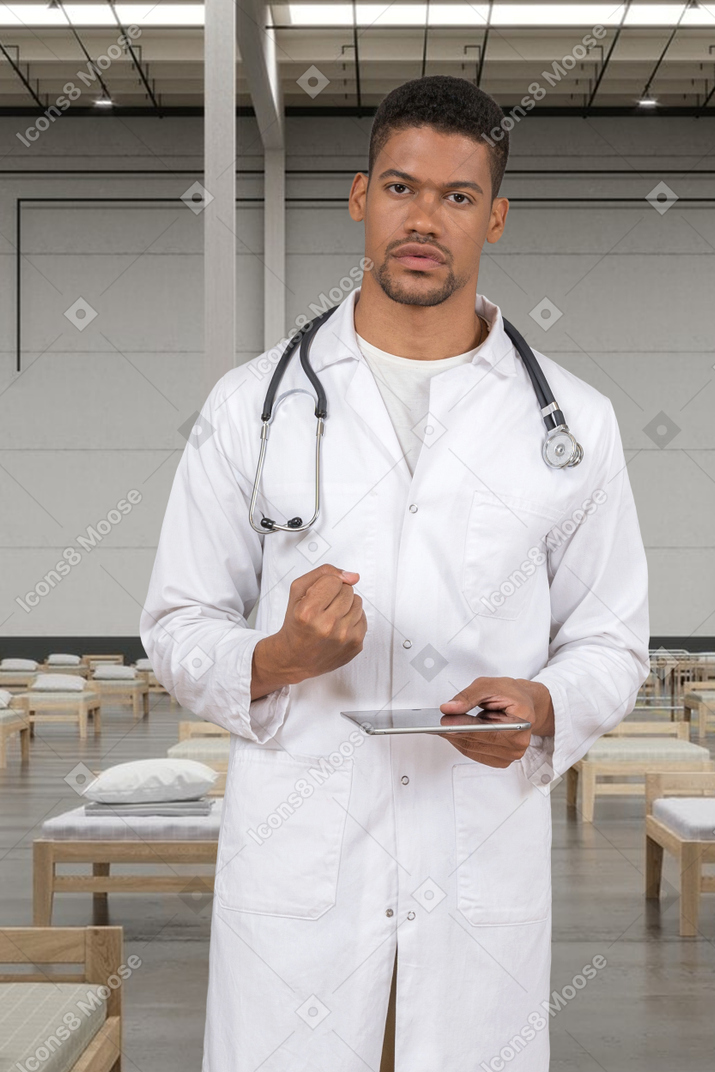 Doctor holding tablet and showing fist