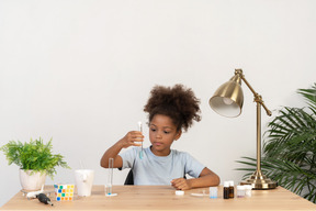 Good looking cute girl doing science at the table